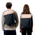 Lieblingstasche Helsinki rolltop backpack in beige and dark grey worn by a man and woman on a white background