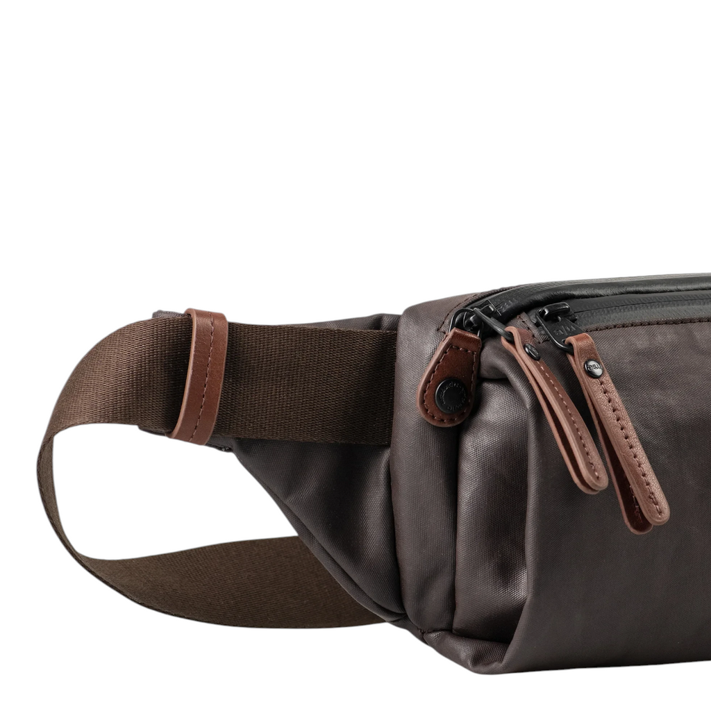 Lieblingstasche Himeji dark brown belt bag with leather accents and adjustable strap against a white background