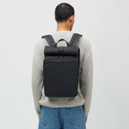 Lieblingstasche Kapten & Son Lund Pro rolltop backpack in black worn by a man in a beige sweater