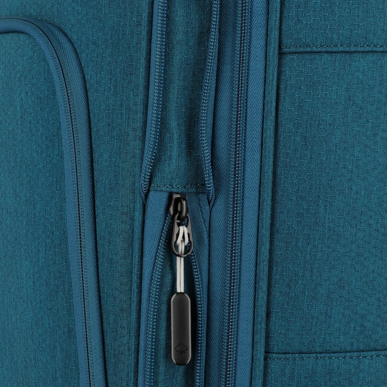 Close-up of the Lieblingstasche KICK OFF trolley suitcase in petrol blue featuring durable fabric and zipper detail.