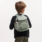 Lieblingstasche Kids Adventure Daypack in sage green made from recycled plastic, worn by a child on a white background