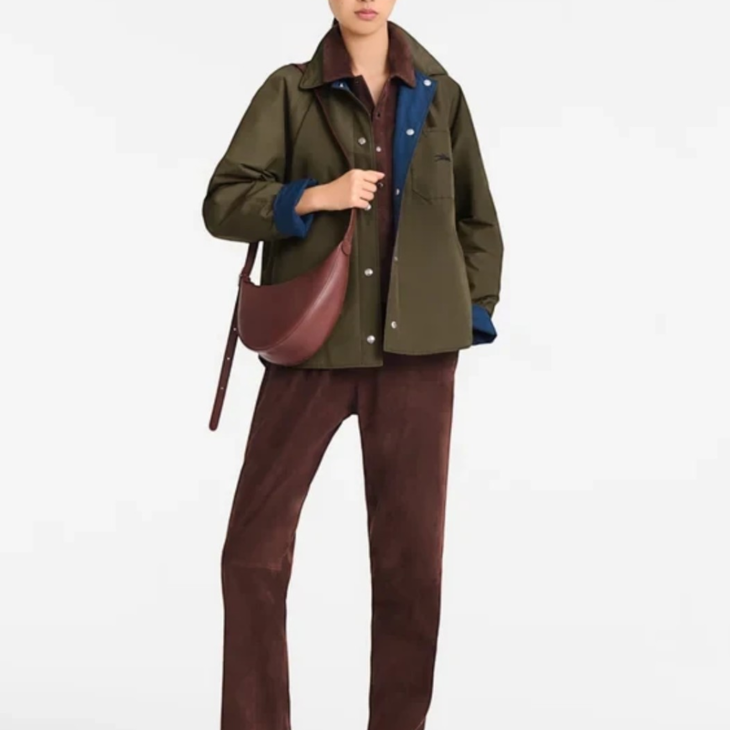 Lieblingstasche Le Foulonné small burgundy leather crescent crossbody bag worn by a model in a casual outfit