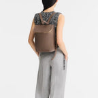 Lieblingstasche Le Foulonné Rucksack in taupe leather with gold zipper and multiple interior compartments.