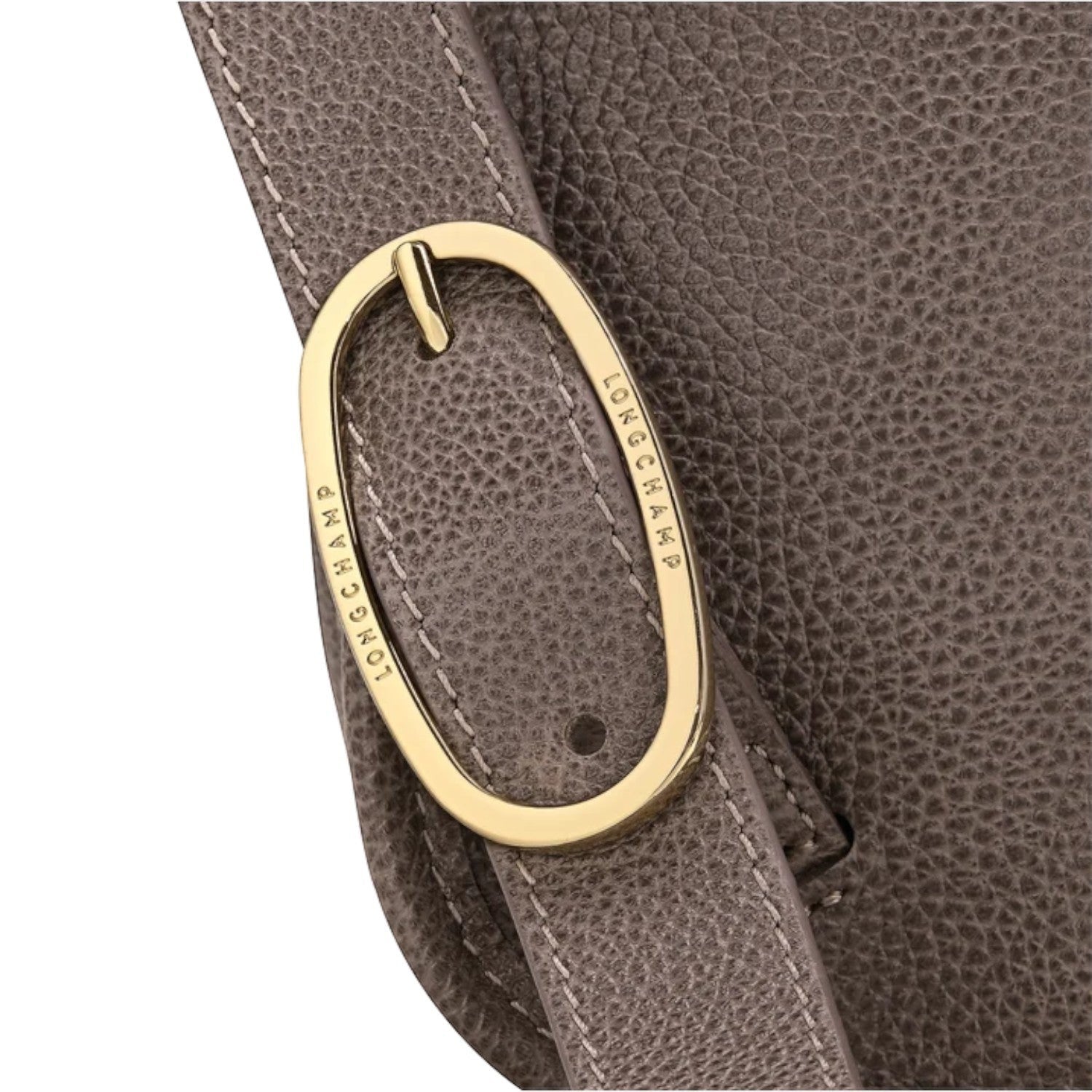 Lieblingstasche Le Foulonné Rucksack in taupe textured leather with gold buckle detail and white stitching.