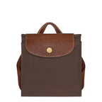 Lieblingstasche Le Pliage rucksack in brown nylon with a textured leather flap and gold-tone snap button closure.