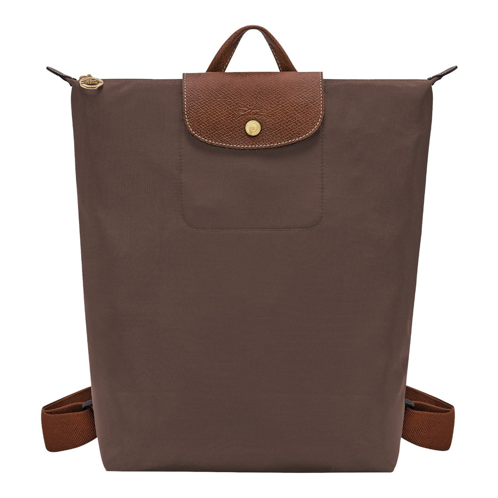 Lieblingstasche Le Pliage brown nylon rucksack with a textured leather flap and gold-tone snap button closure.