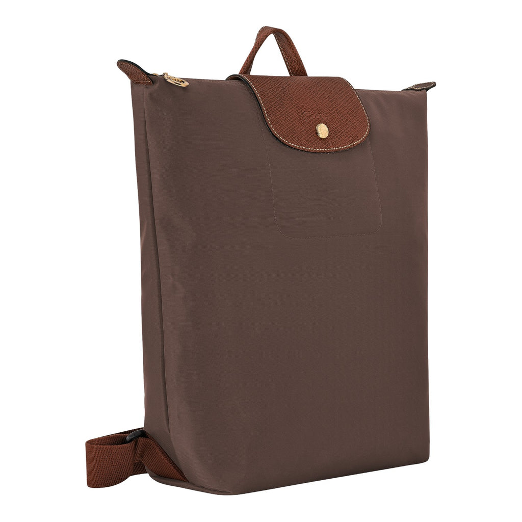 Lieblingstasche Le Pliage rucksack in brown nylon with a textured leather flap and gold-tone snap button closure.