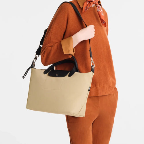 Lieblingstasche Le Pliage Energy beige recycled nylon handbag with black handles and rope detail worn by a model
