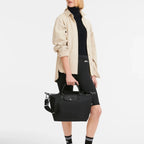 Lieblingstasche Le Pliage Energy black recycled nylon handbag with rope detail held by a model in casual outfit
