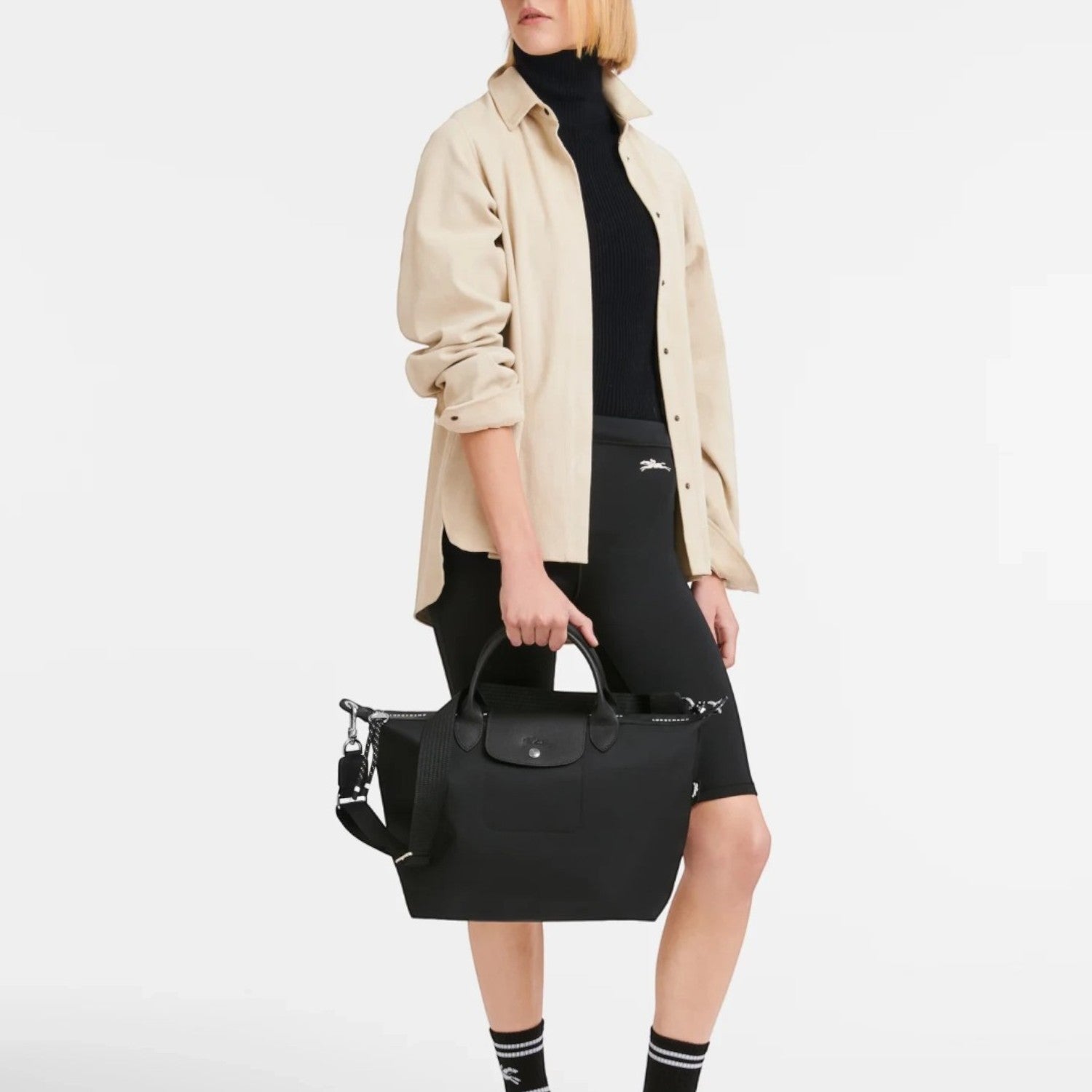 Lieblingstasche Le Pliage Energy black recycled nylon handbag with rope detail held by a model in casual outfit