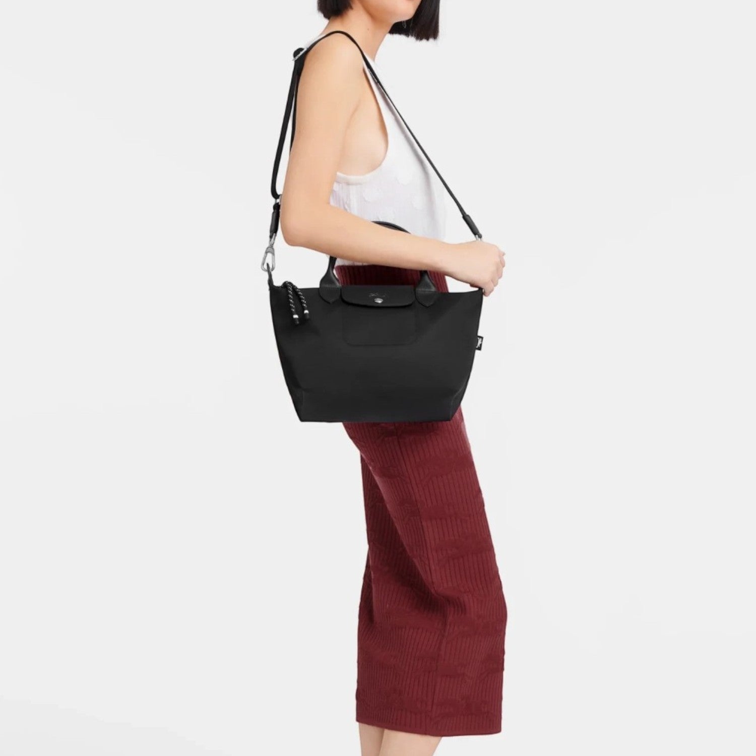 Lieblingstasche Le Pliage Energy S black recycled nylon handbag with shoulder strap worn by a woman