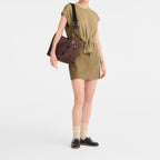 Lieblingstasche Le Pliage Energy medium brown crossbody bag worn by a model in a matching olive green outfit