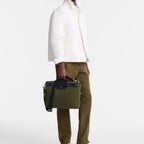 Lieblingstasche Le Pliage Energy olive green business bag with black leather trim held by a man in a white jacket