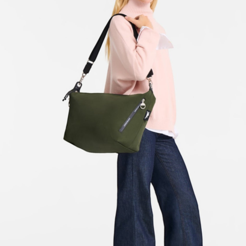 Lieblingstasche Le Pliage Energy olive green crossbody bag worn by a blonde model in a pink sweater and jeans