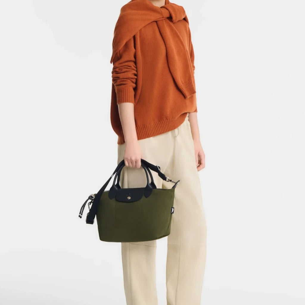 Lieblingstasche Le Pliage Energy small handbag in olive green recycled nylon with black rope details held by a model
