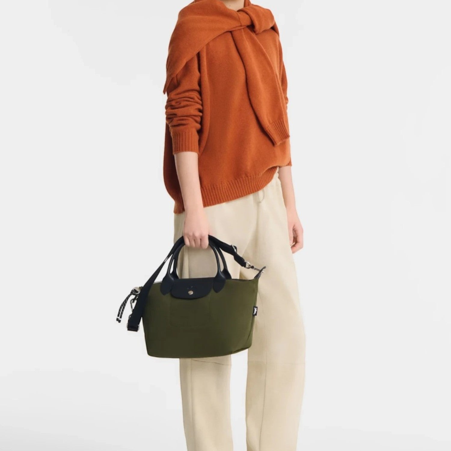 Lieblingstasche Le Pliage Energy small handbag in olive green recycled nylon with black rope details held by a model