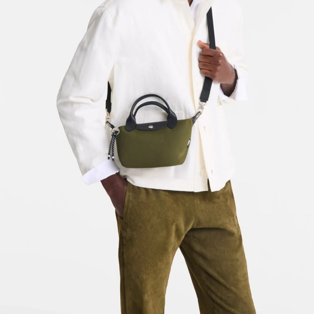 Lieblingstasche Le Pliage Energy XS olive green recycled nylon handbag with black rope detail worn by a male model