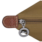 Lieblingstasche Le Pliage L handbag detail showing brown nylon fabric, textured leather trim, and silver zipper pull