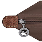Lieblingstasche Le Pliage handbag detail showing brown nylon fabric, leather trim, and silver logo zipper pull