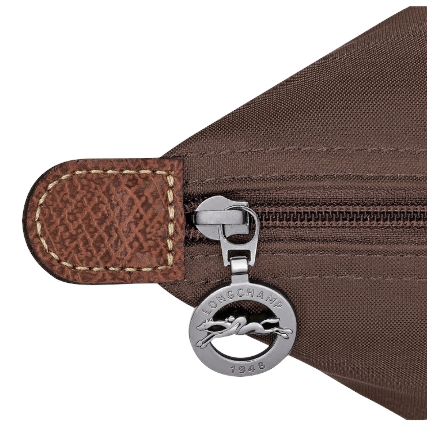 Lieblingstasche Le Pliage handbag detail showing brown nylon fabric, leather trim, and silver logo zipper pull