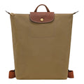 Lieblingstasche Le Pliage rucksack in khaki nylon with brown leather flap, gold snap button, and adjustable straps.