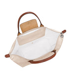 Lieblingstasche Le Pliage L handbag in cream nylon with brown leather trim and handles. Open top with zip closure.