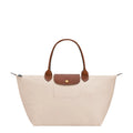 Lieblingstasche Le Pliage L cream nylon handbag with brown leather trim and handles.