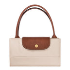 Lieblingstasche Le Pliage L handbag in cream canvas with brown leather trim and handles.