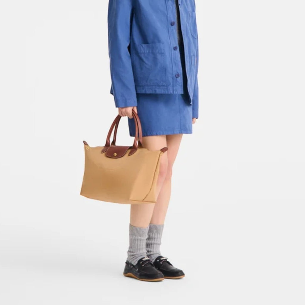 Lieblingstasche Le Pliage L handbag in tan nylon with brown leather handles and trim.