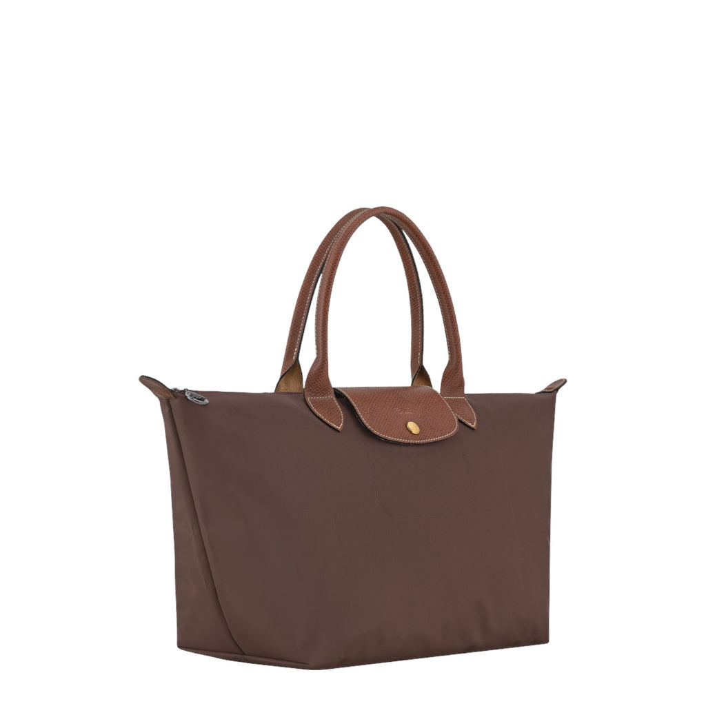 Lieblingstasche Le Pliage large brown handbag with leather handles and flap closure on a black background