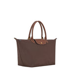 Lieblingstasche Le Pliage large brown handbag with leather handles and flap closure on a black background