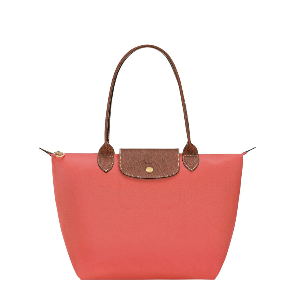 Lieblingstasche Le Pliage M tote bag in coral nylon with brown leather trim and handles.