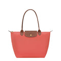 Lieblingstasche Le Pliage M tote bag in coral nylon with brown leather trim and handles.
