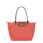 Lieblingstasche Le Pliage M tote bag in coral nylon with brown leather trim and handles.