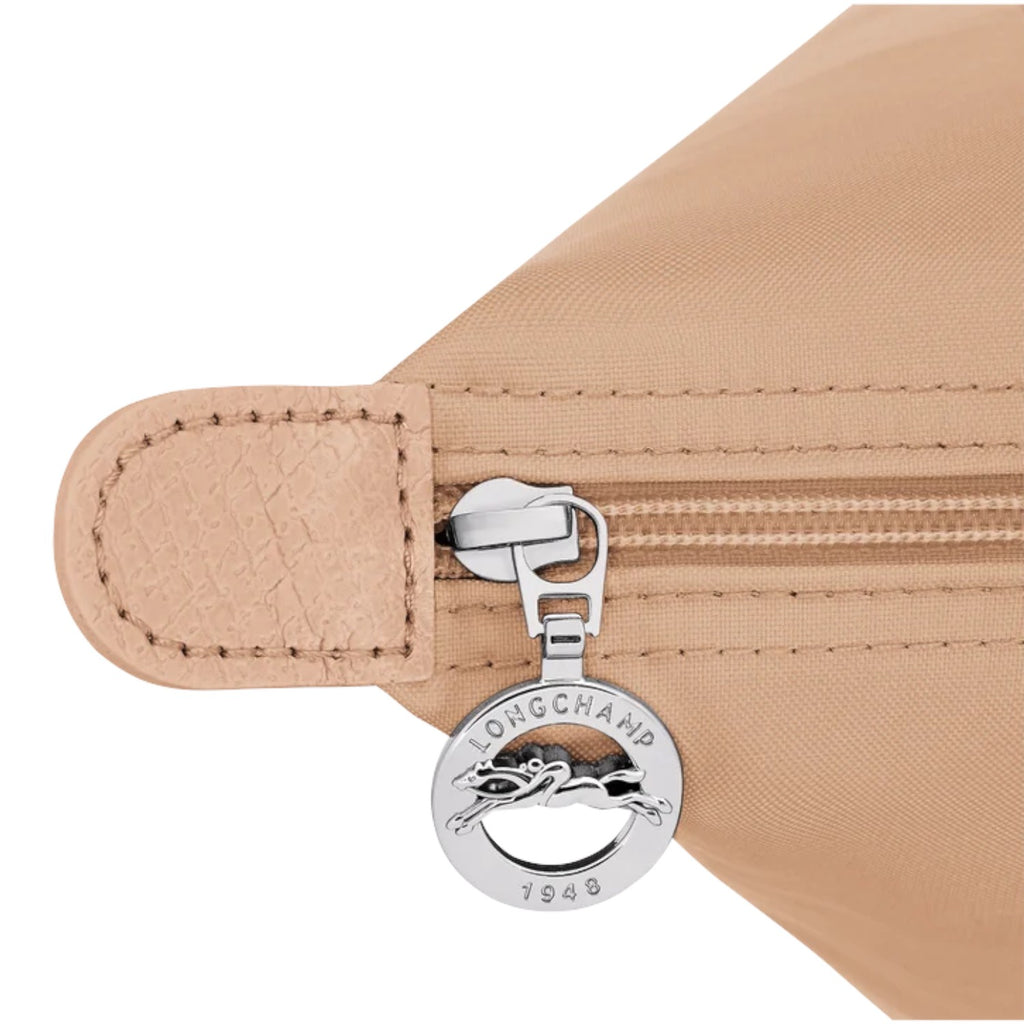 Lieblingstasche Le Pliage One handbag in beige nylon with leather trim and silver zipper pull with Longchamp logo.