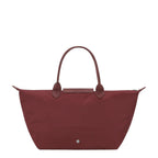 Lieblingstasche Le Pliage One handbag in burgundy nylon with leather trim and handles.