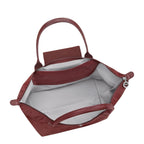 Lieblingstasche Le Pliage One L shoulder bag in burgundy nylon with leather trim and handles. Interior features a slip pocket.