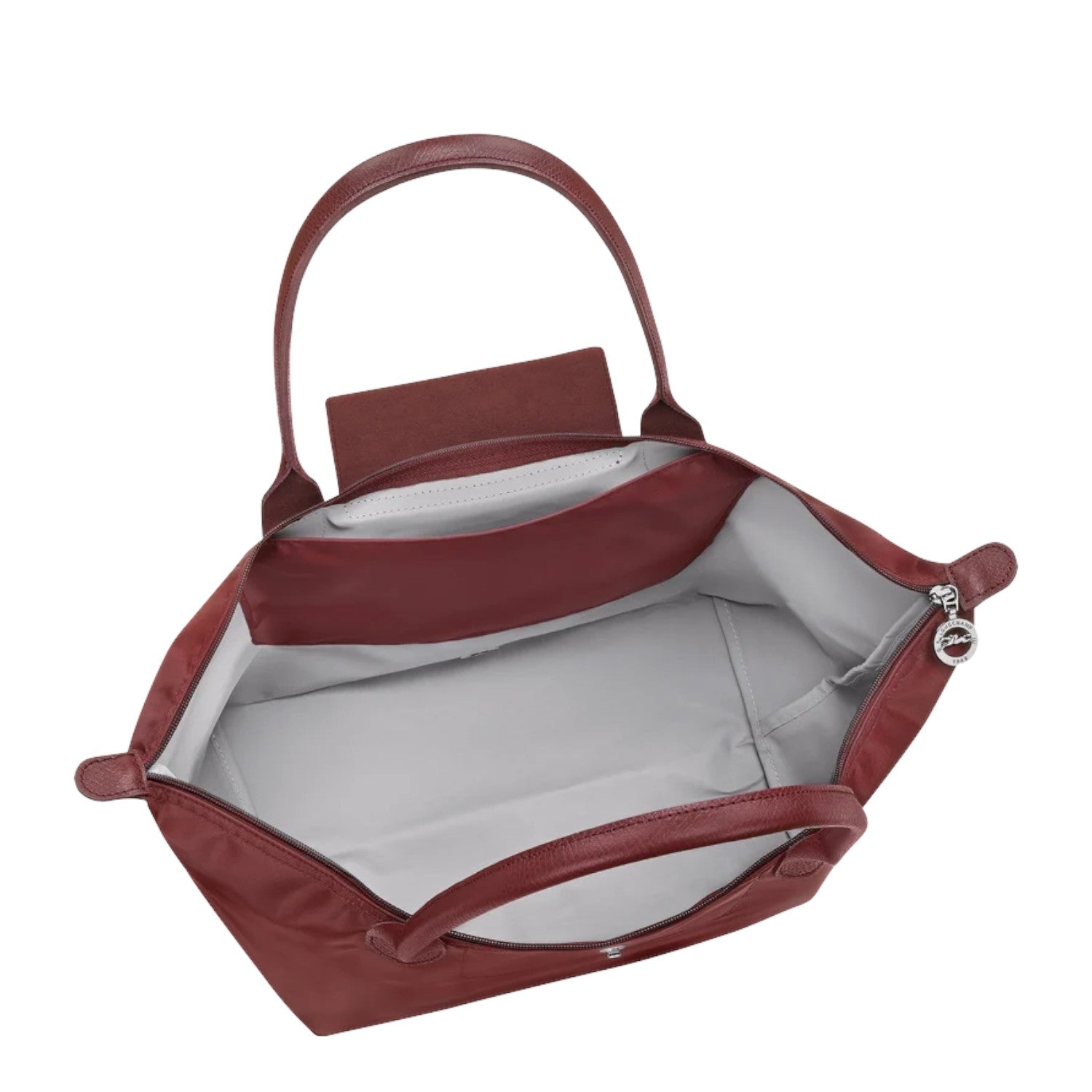 Lieblingstasche Le Pliage One L shoulder bag in burgundy nylon with leather trim and handles. Interior features a slip pocket.