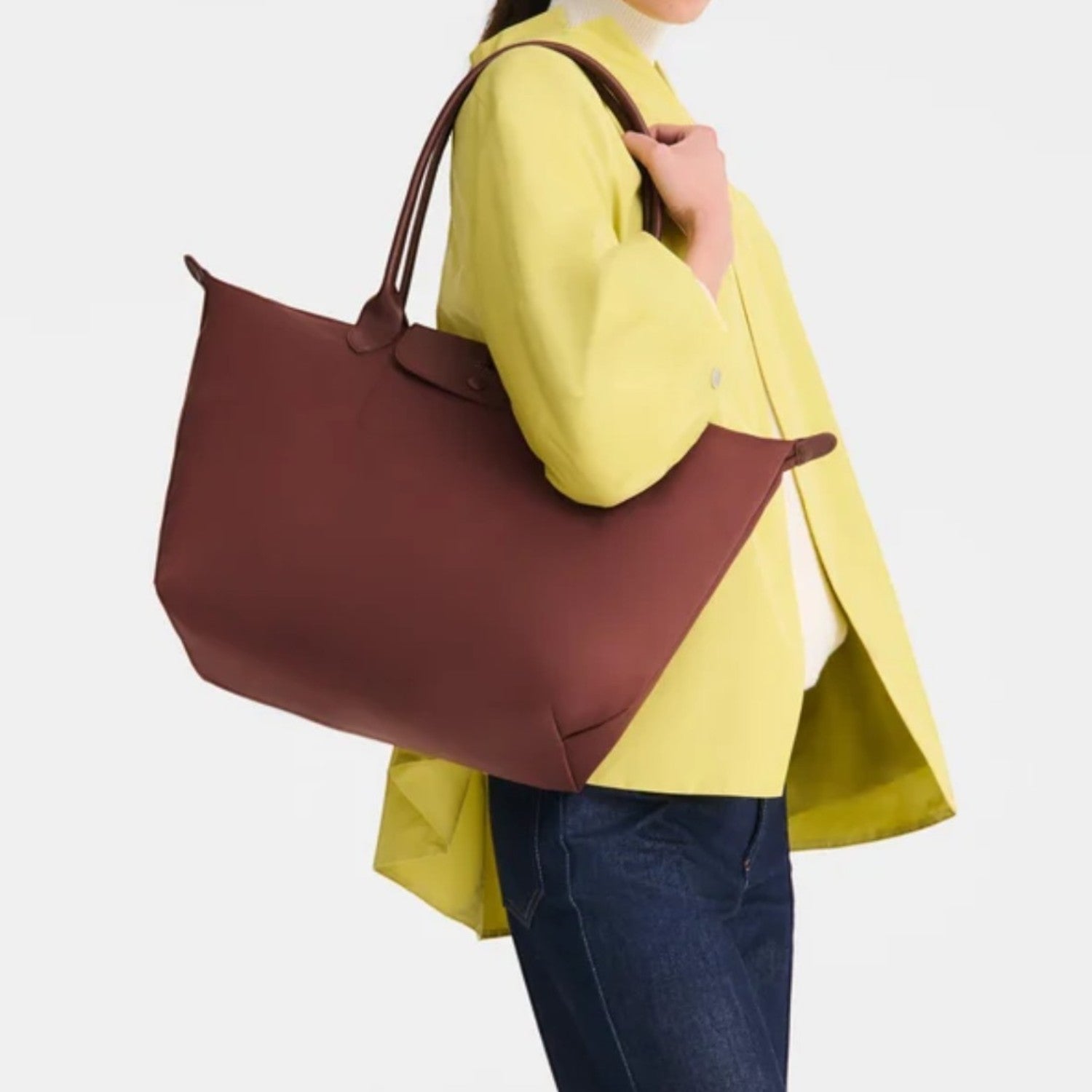 Lieblingstasche Le Pliage One L shoulder bag in dark red nylon with leather trim, worn by a model.