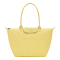 Lieblingstasche Le Pliage One L tote bag in pale yellow leather with a snap-button flap pocket and top handles.