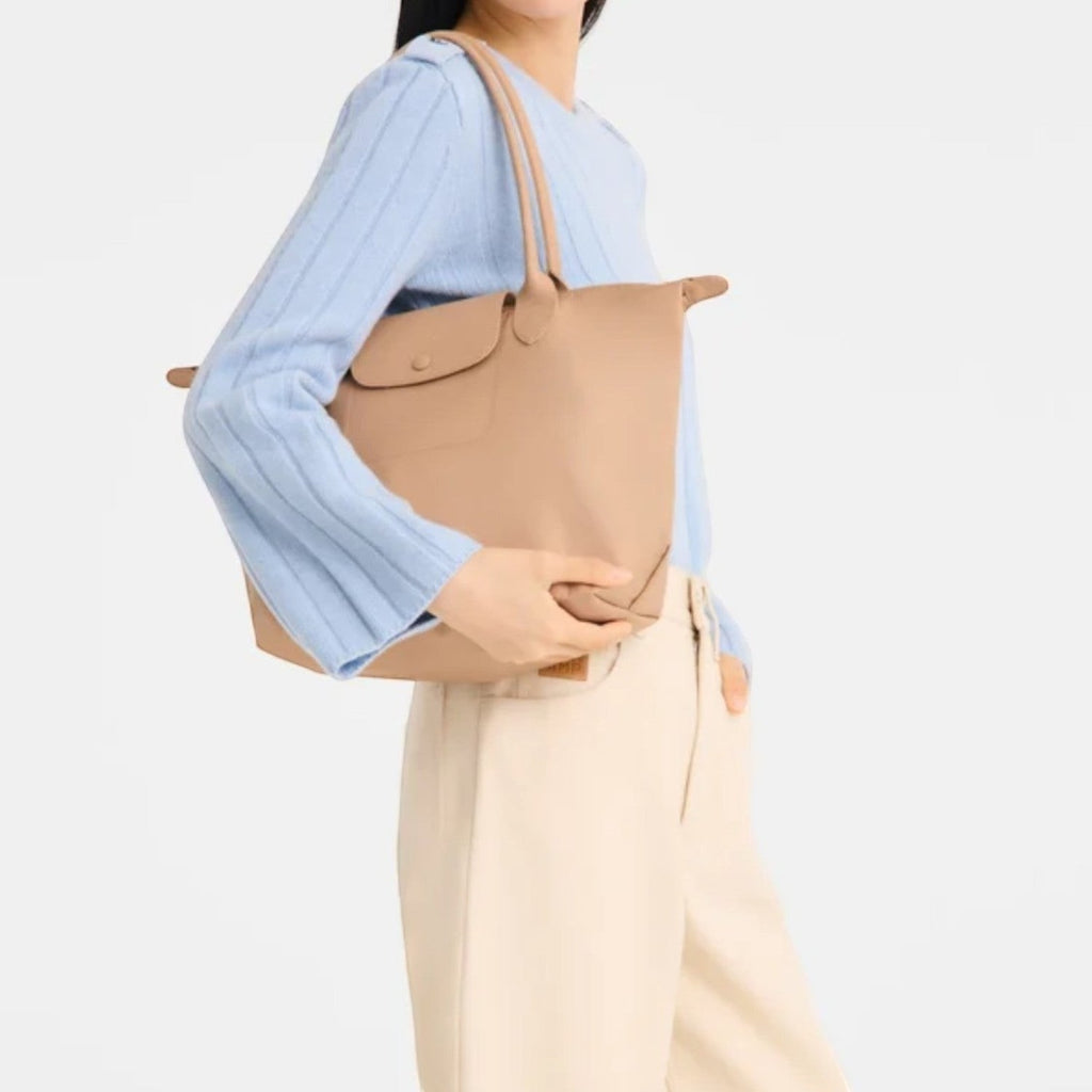 Lieblingstasche Le Pliage One M shoulder bag in beige leather with top handles and a flap closure.