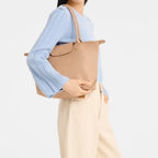 Lieblingstasche Le Pliage One M shoulder bag in beige leather with top handles and a flap closure.