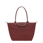 Lieblingstasche Le Pliage One M shoulder bag in red nylon with leather trim and snap closure.