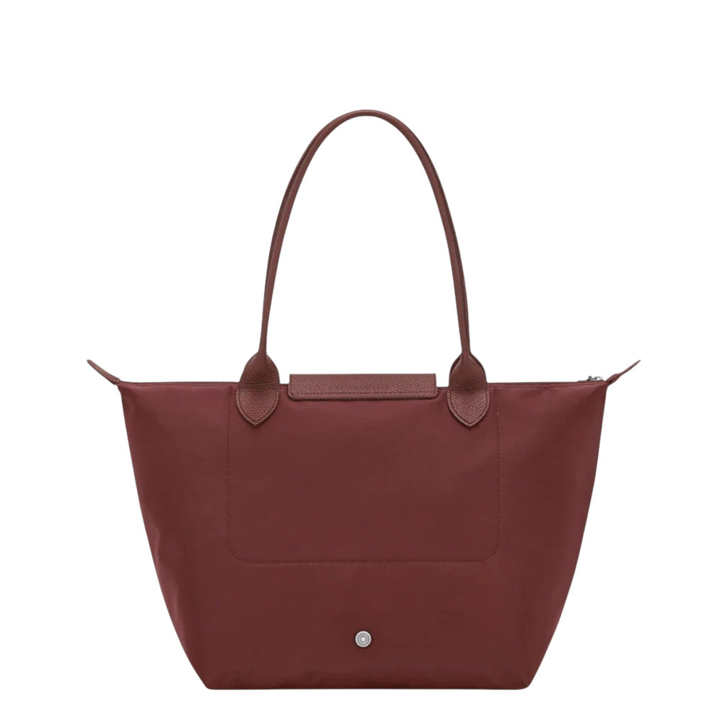 Lieblingstasche Le Pliage One M shoulder bag in deep red nylon with leather trim and handles. Features a snap closure and zippered top.