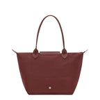 Lieblingstasche Le Pliage One M shoulder bag in deep red nylon with leather trim and handles. Features a snap closure and zippered top.
