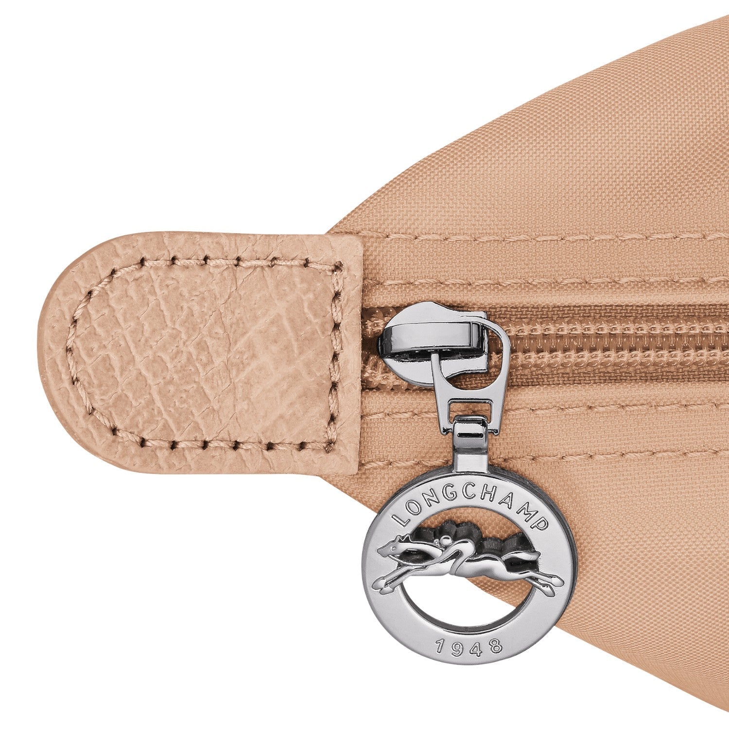 Lieblingstasche Le Pliage One Rucksack in beige nylon with leather trim and silver zipper pull featuring the Longchamp logo.