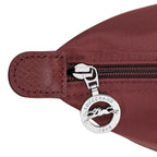 Lieblingstasche Le Pliage One Rucksack in burgundy nylon with leather trim and silver zipper pull featuring a horse logo.