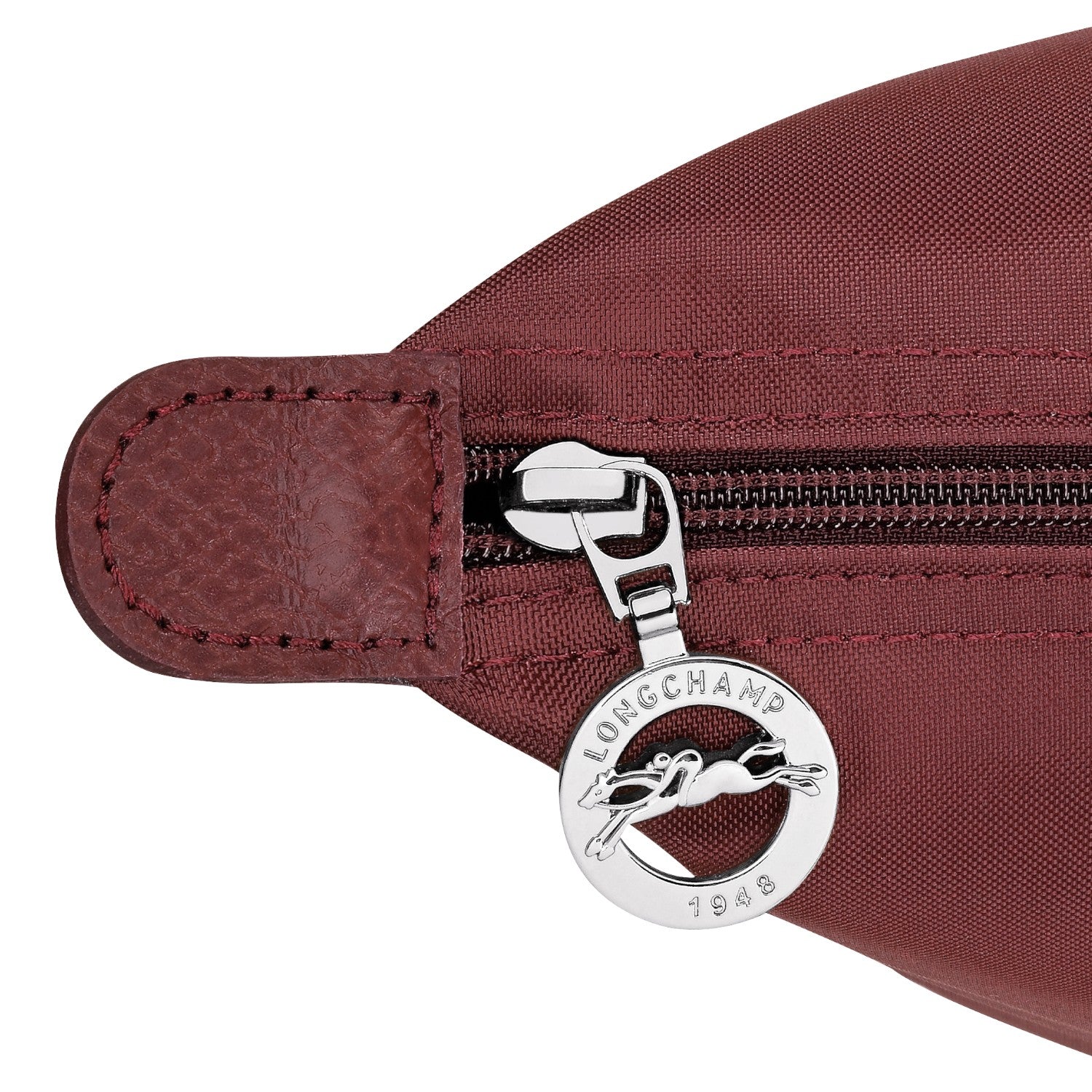 Lieblingstasche Le Pliage One Rucksack in burgundy nylon with leather trim and silver zipper pull featuring a horse logo.