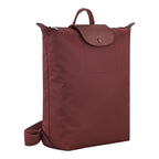 Lieblingstasche Le Pliage One Rucksack in deep red nylon with leather trim and snap closure.