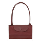 Lieblingstasche Le Pliage One shoulder bag in dark red nylon with leather trim and a snap closure.